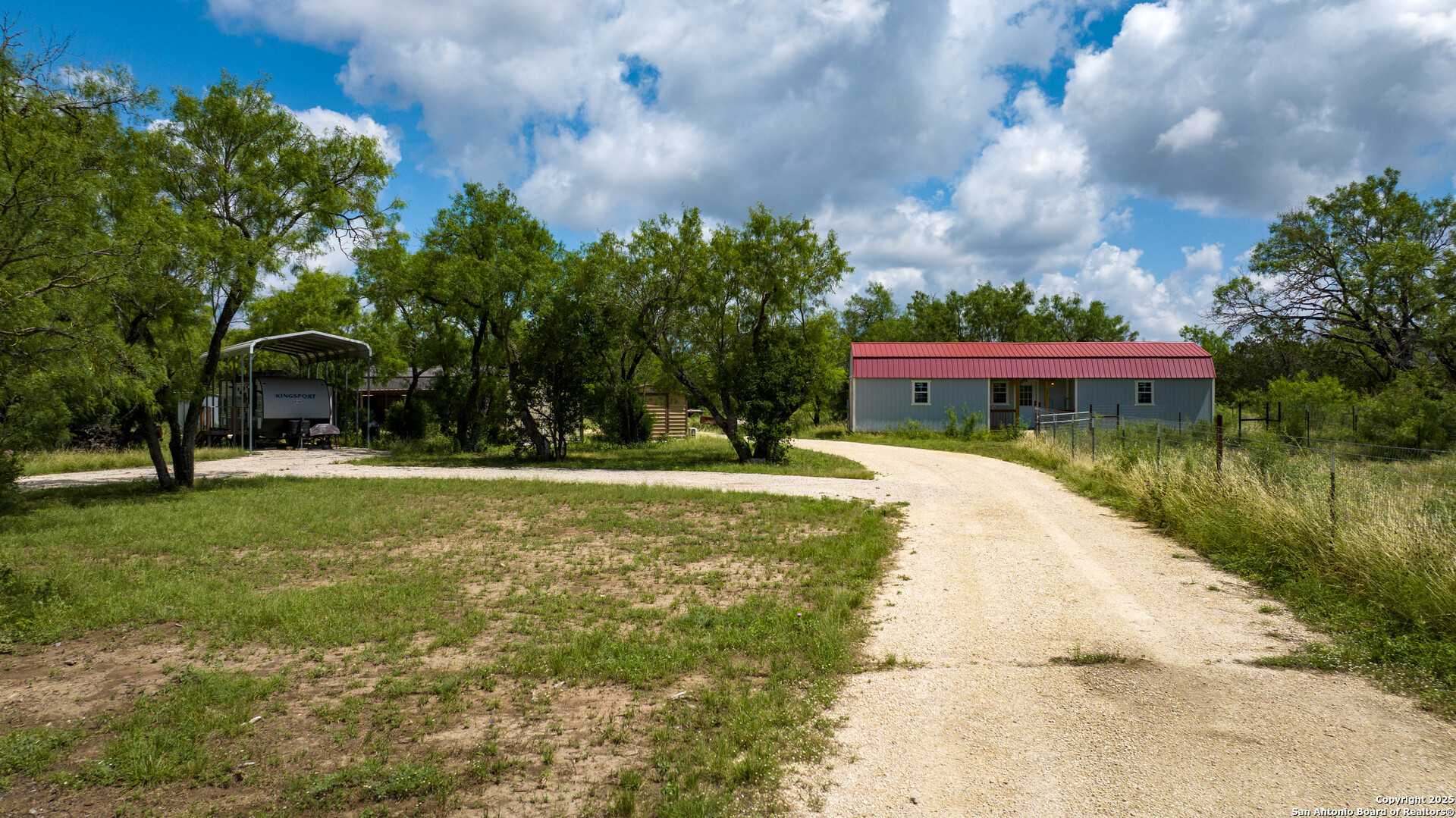 1231 B & R Road Vanderpool, TX 78885 - Photo 3 of 26 a view of house with garden space and trees