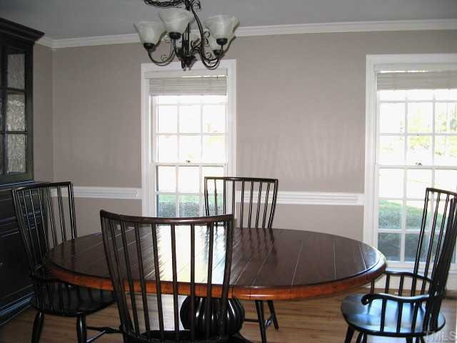 308 Sandhurst Road Raleigh, NC 27615 - Photo 4 of 12 Formal dining room with chair rail, hardwoods, & two tall windows Dining Room