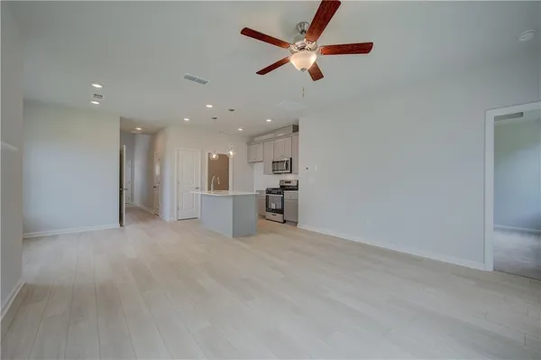 a view of a kitchen with a sink and a refrigerator