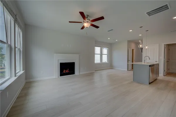 a view of a livingroom with a ceiling fan and window