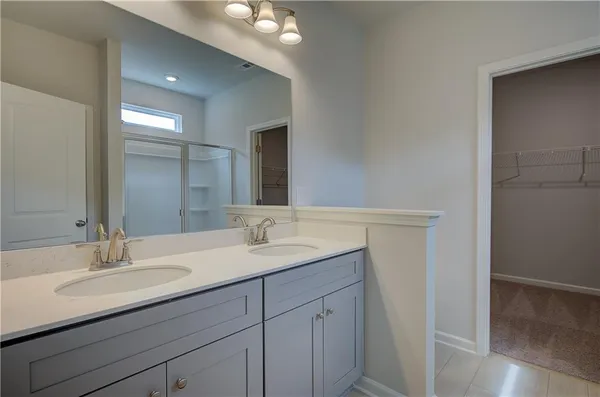a bathroom with a sink double vanity and a mirror