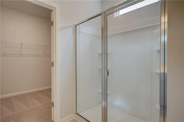 a bathroom with a glass shower door