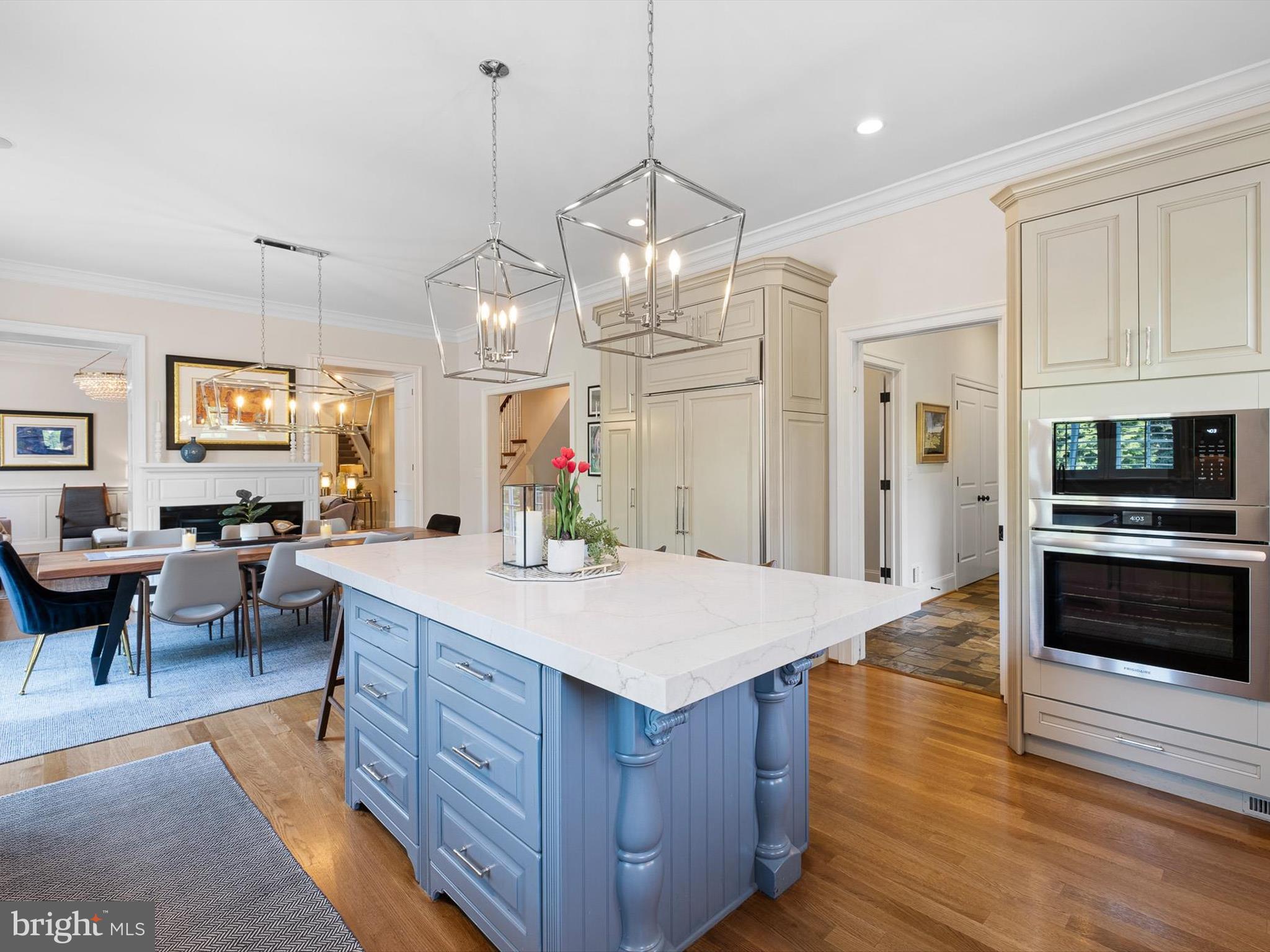 2 A Courtney Road Wilmington, DE 19807 - Photo 21 of 52 a large kitchen with kitchen island a stove a sink a dining table and chairs with wooden floor