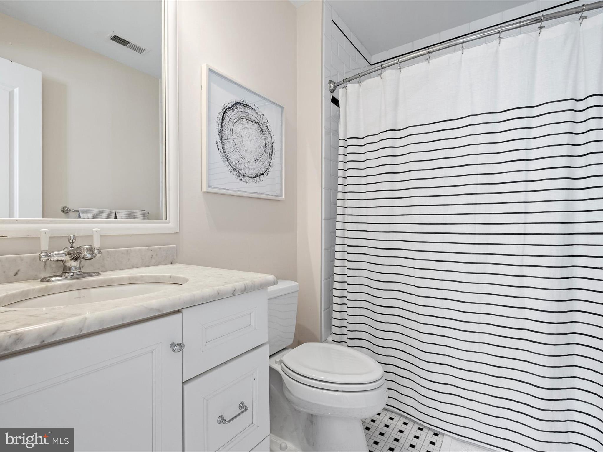 2 A Courtney Road Wilmington, DE 19807 - Photo 41 of 52 a bathroom with a toilet a sink and a mirror
