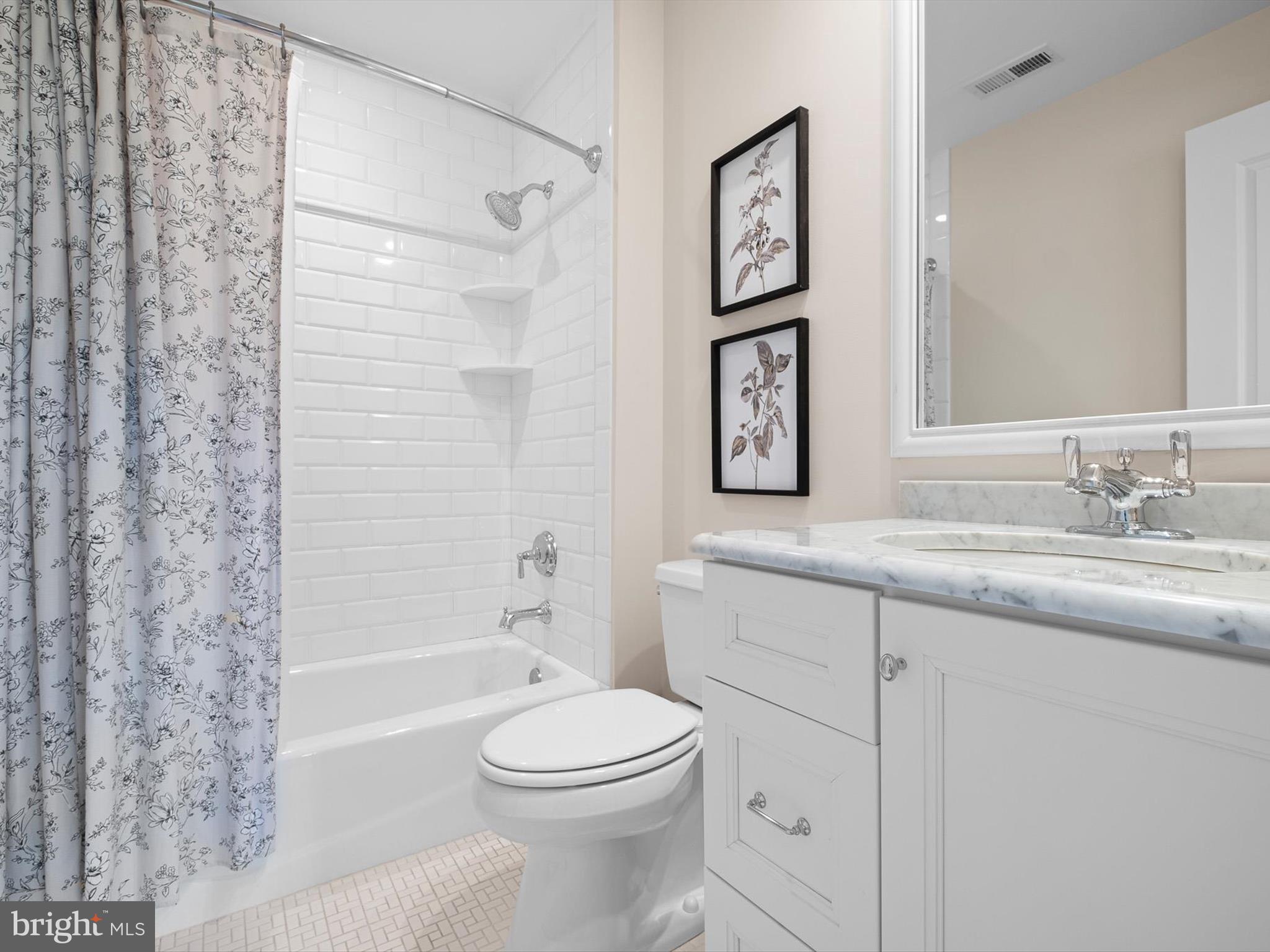 2 A Courtney Road Wilmington, DE 19807 - Photo 44 of 52 a bathroom with a granite countertop toilet a sink and a bathtub