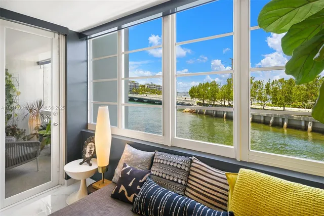 a living room with a large window and floor to ceiling window