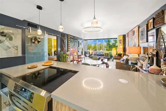 a open kitchen with stainless steel appliances granite countertop a sink a stove and a refrigerator