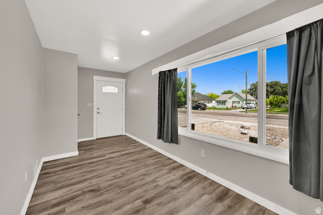 716 East Factory Street Garland, UT 84312 - Photo 10 of 30 Inviting entry space featuring wood-finish flooring, recessed lighting, and a prominent front door with an arched glass insert