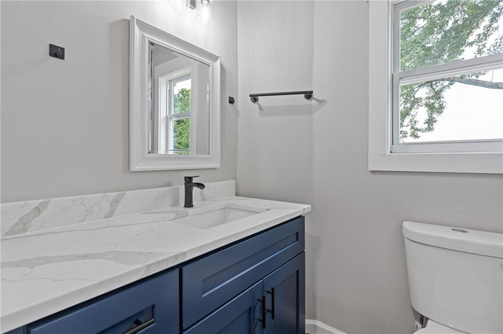 1164 Red Oak Cove Tucker, GA 30084 - Photo 14 of 24 a bathroom with a sink a toilet and a window