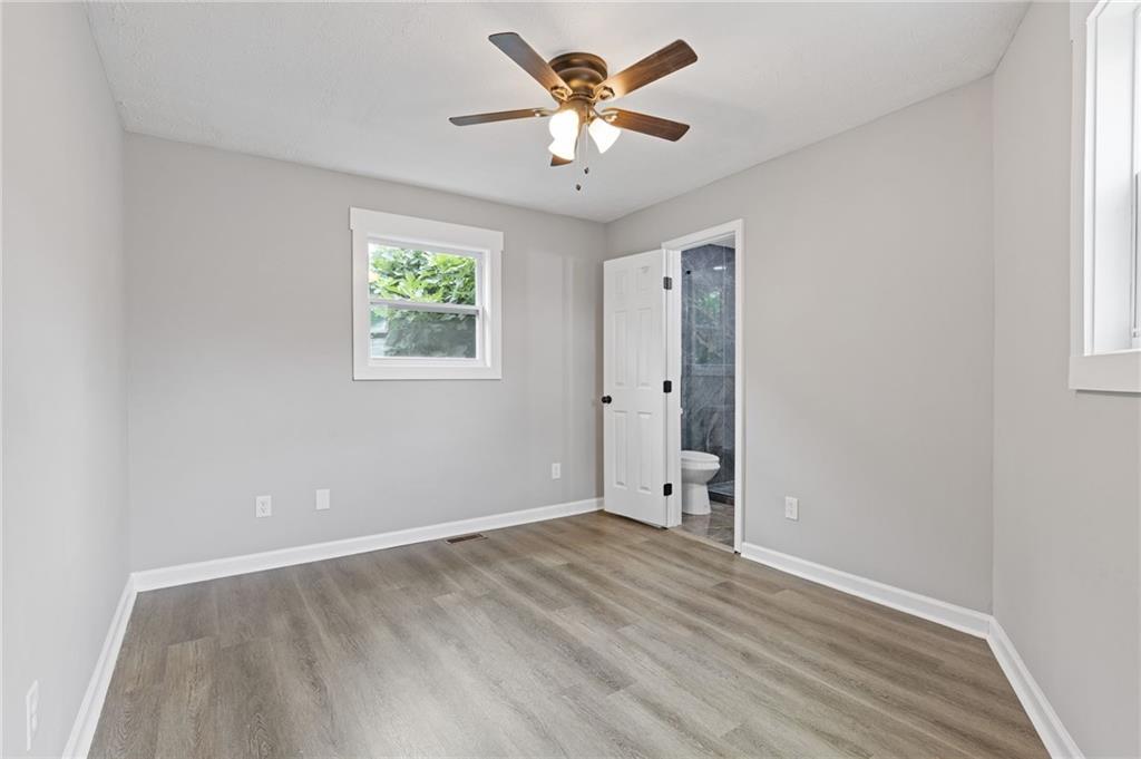 1164 Red Oak Cove Tucker, GA 30084 - Photo 17 of 24 wooden floor in an empty room with a window