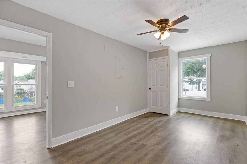 1164 Red Oak Cove Tucker, GA 30084 - Photo 7 of 24 a view of an empty room with wooden floor and a window