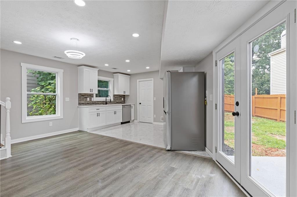 1164 Red Oak Cove Tucker, GA 30084 - Photo 8 of 24 a view of kitchen with wooden floor electronic appliances and window