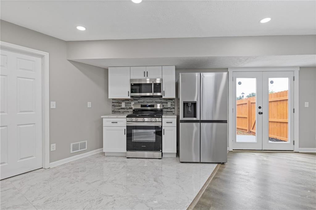 1164 Red Oak Cove Tucker, GA 30084 - Photo 10 of 24 a kitchen with a refrigerator and a stove top oven