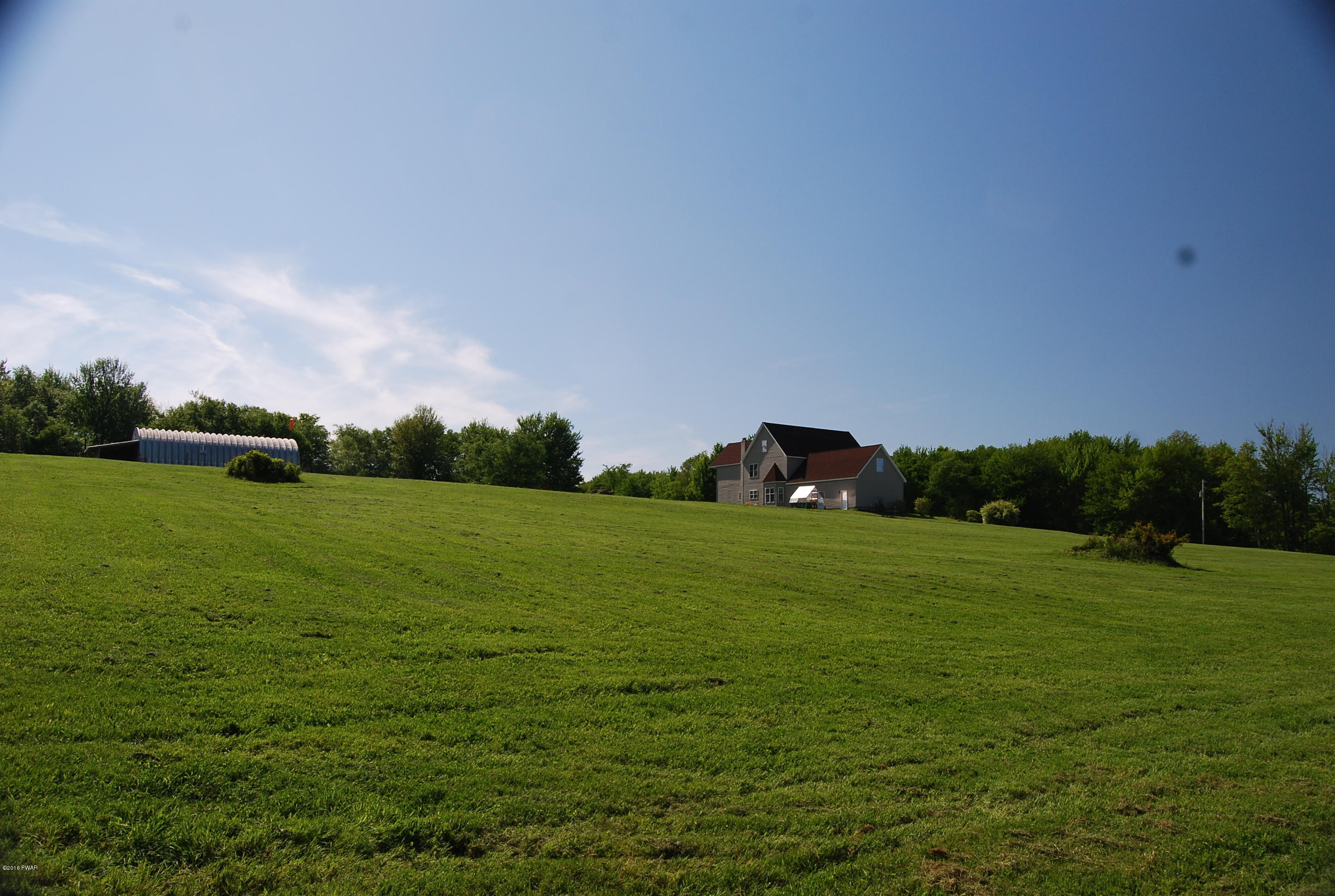 176 Highland Road Pleasant Mount, PA 18453 - Photo 37 of 52 a backyard of a house with lots of green space