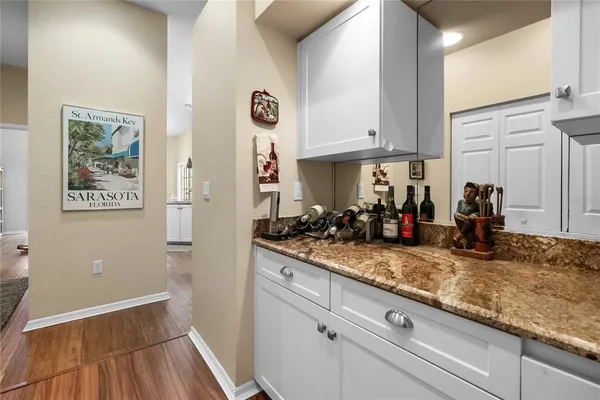 a view of a kitchen with a sink and refrigerator
