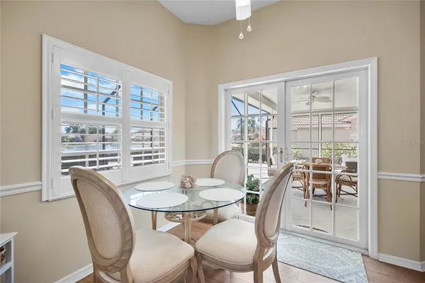 a dining room with furniture a window and wooden floor