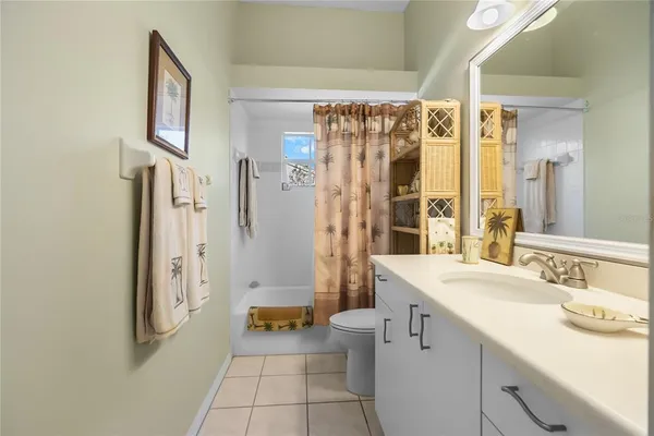 a spacious bathroom with a shower sink and a mirror