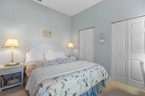 a bedroom with a bed and a lamp