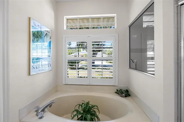 a bath tub sitting in a bathroom next to a window