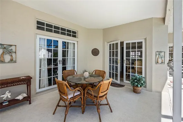 a dining room with furniture and a potted plant