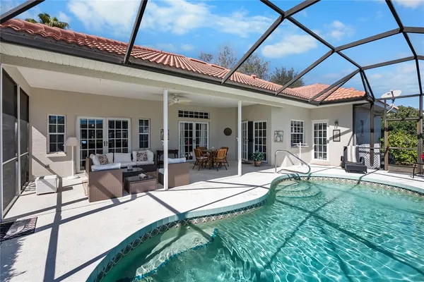 a view of a house with backyard porch and sitting area