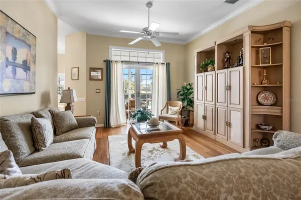 a living room with furniture a window and a flat screen tv