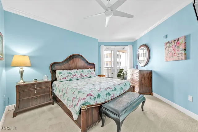 a bedroom with a bed mirror on desk and a window