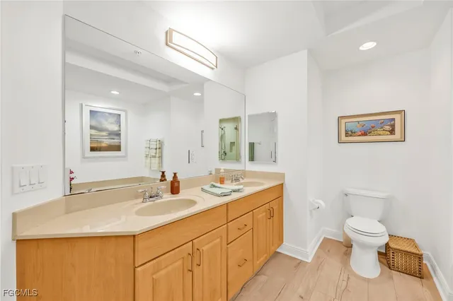 a bathroom with a sink a toilet and mirror