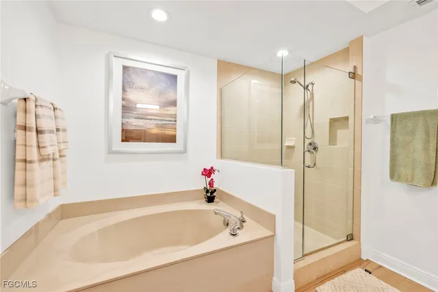 a white bath tub sitting next to a shower