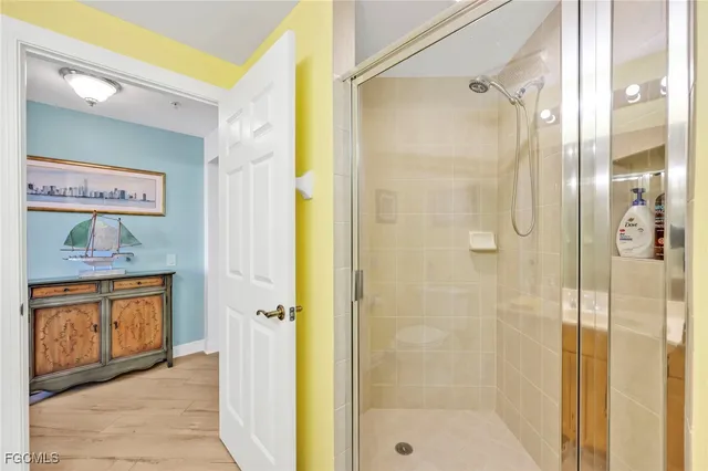 a bathroom with a tub shower sink and a mirror