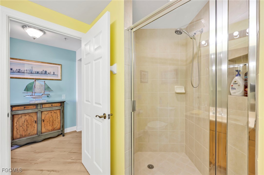 2743 First Street, Unit 1206 Fort Myers, FL 33916 - Photo 25 of 50 a bathroom with a tub shower sink and a mirror