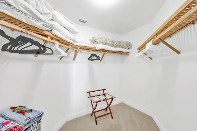 a bedroom with a large bed and dresser