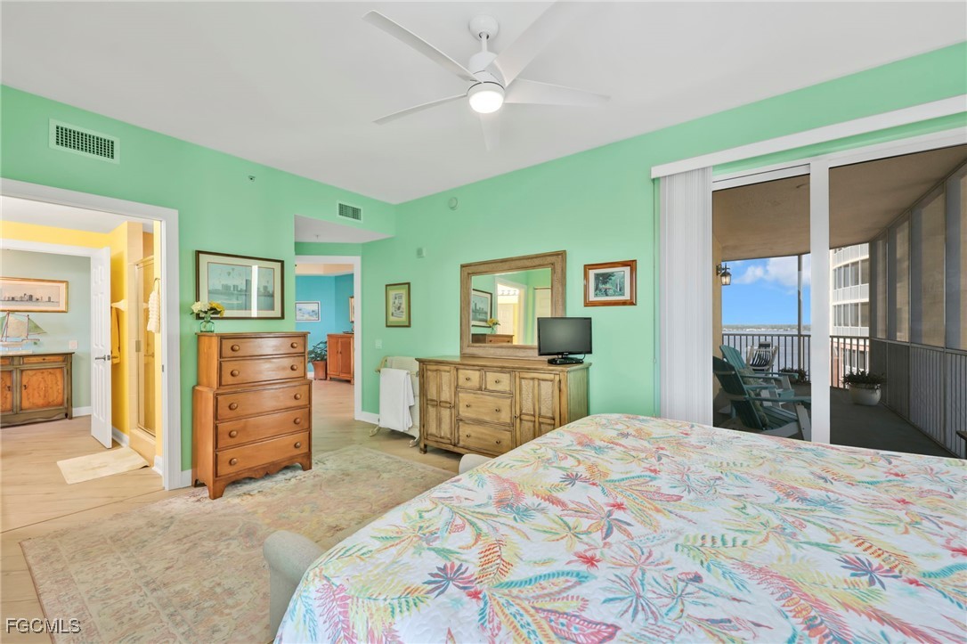 2743 First Street, Unit 1206 Fort Myers, FL 33916 - Photo 27 of 50 a bedroom with a large bed and dresser