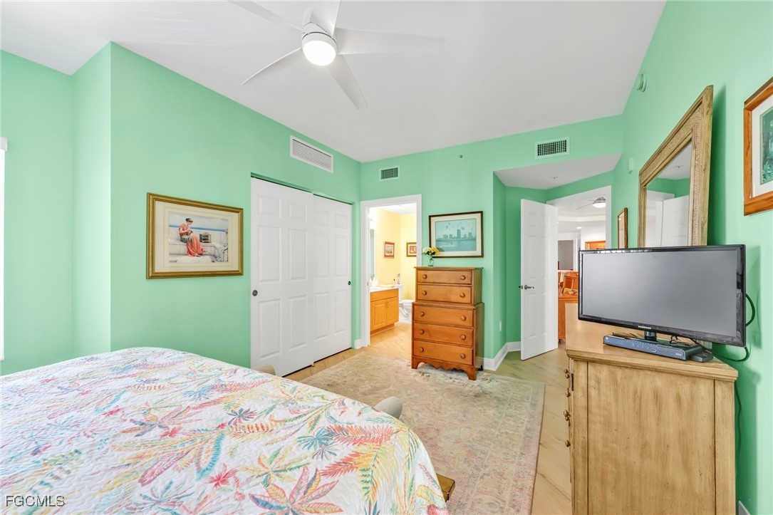 2743 First Street, Unit 1206 Fort Myers, FL 33916 - Photo 28 of 50 a bedroom with a bed and a flat screen tv
