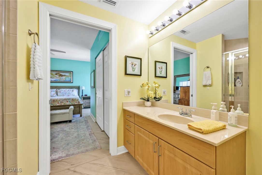 2743 First Street, Unit 1206 Fort Myers, FL 33916 - Photo 29 of 50 a en suite bathroom with a sink and a mirror