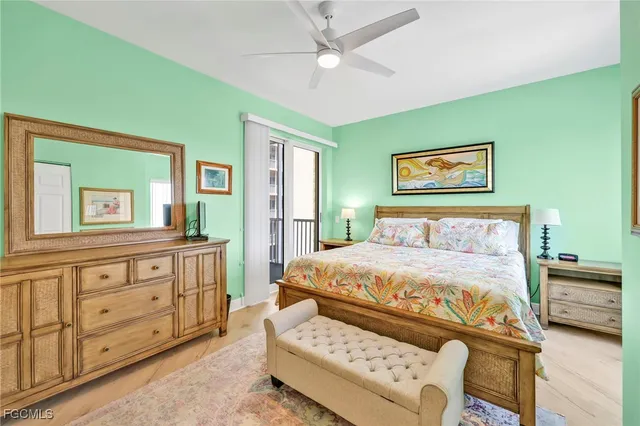 a spacious bedroom with a bed and a chandelier