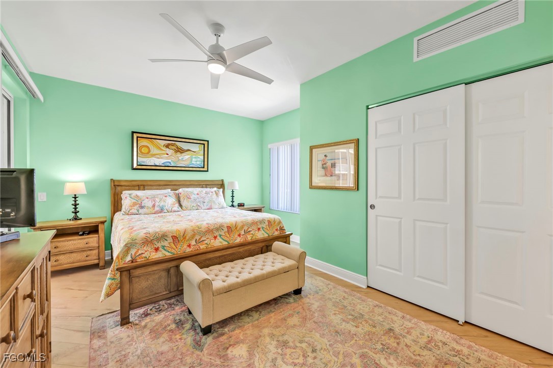 2743 First Street, Unit 1206 Fort Myers, FL 33916 - Photo 31 of 50 a spacious bedroom with a bed and a chandelier