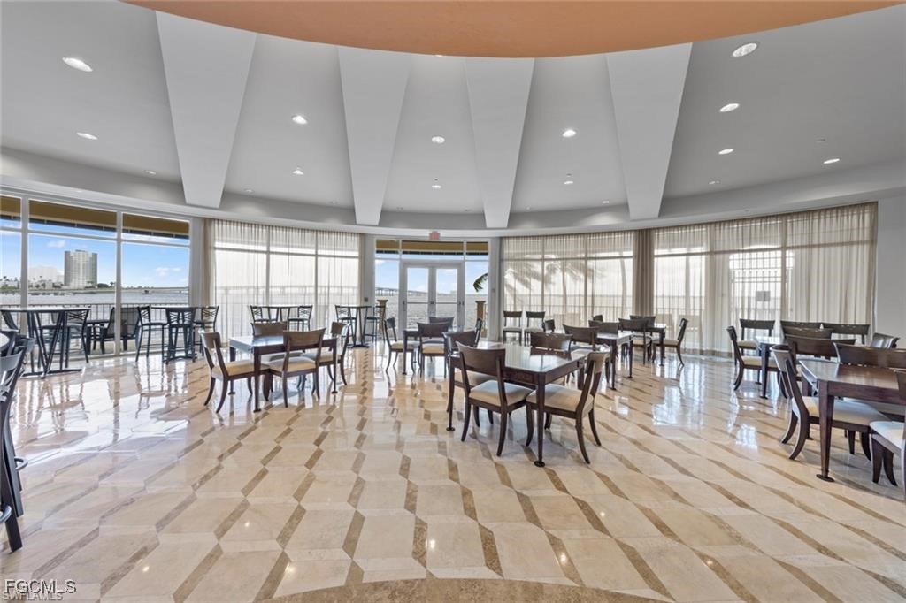 2743 First Street, Unit 1206 Fort Myers, FL 33916 - Photo 41 of 50 a view of a dining area with furniture and chandelier