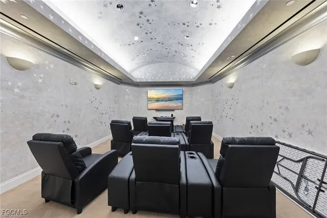 a dining hall with stainless steel appliances a dining table chairs and couches