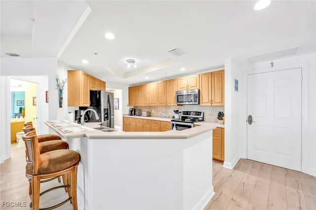 a large kitchen with sink a counter top space and appliances