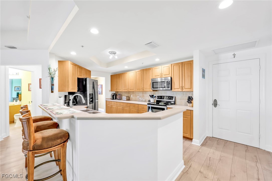 2743 First Street, Unit 1206 Fort Myers, FL 33916 - Photo 5 of 50 a large kitchen with sink a counter top space and appliances