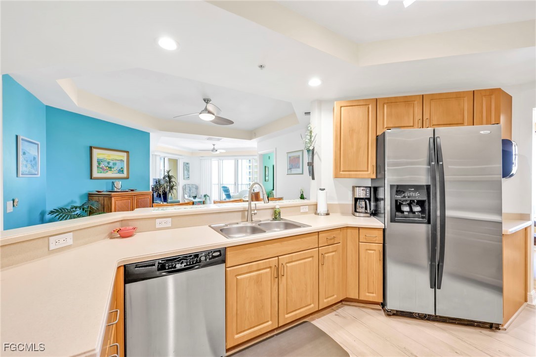 2743 First Street, Unit 1206 Fort Myers, FL 33916 - Photo 7 of 50 a kitchen with a sink and refrigerator