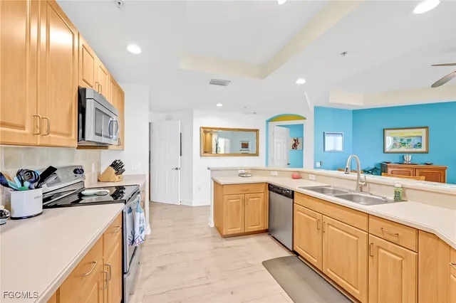 a kitchen with stainless steel appliances granite countertop a sink and cabinets