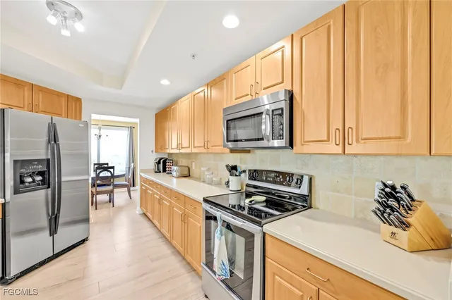 a kitchen with stainless steel appliances granite countertop a stove a sink and a refrigerator