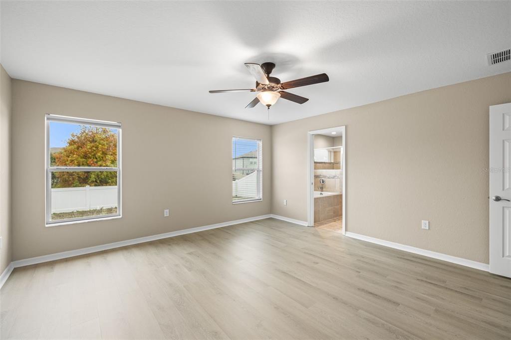3878 White Ibis Road Lakeland, FL 33811 - Photo 14 of 21 a view of an empty room with a window and wooden floor