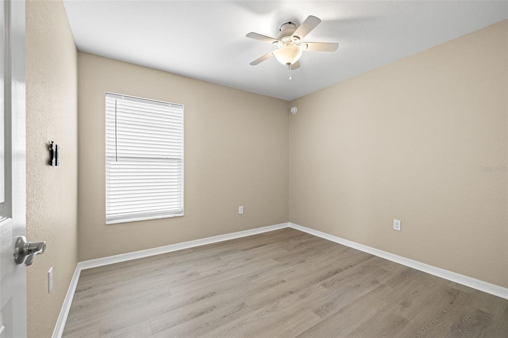 3878 White Ibis Road Lakeland, FL 33811 - Photo 15 of 21 an empty room with a window and a fan