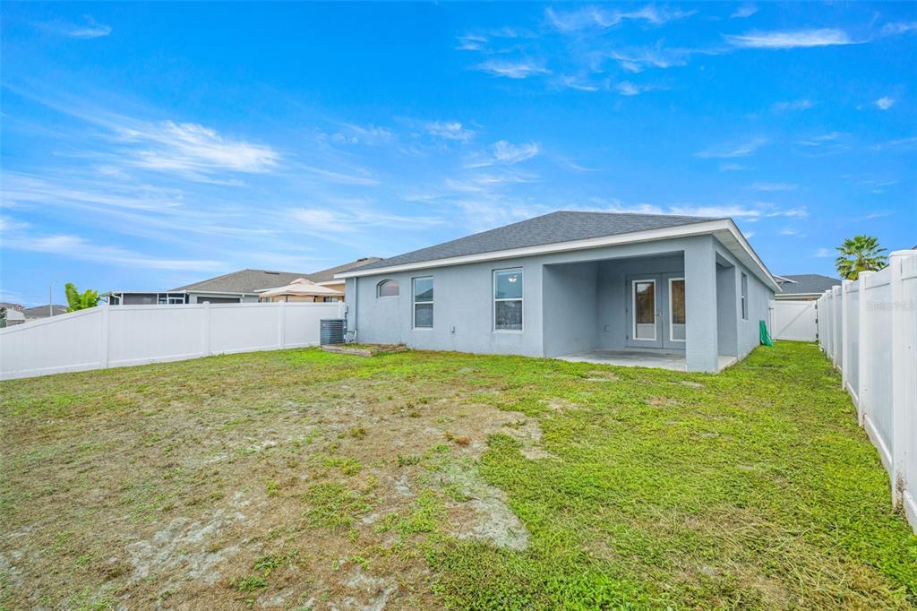 3878 White Ibis Road Lakeland, FL 33811 - Photo 19 of 21 a backyard of a house with plants and large tree