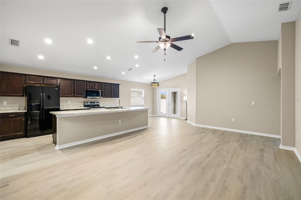 3878 White Ibis Road Lakeland, FL 33811 - Photo 7 of 21 a view of kitchen with cabinets and refrigerator