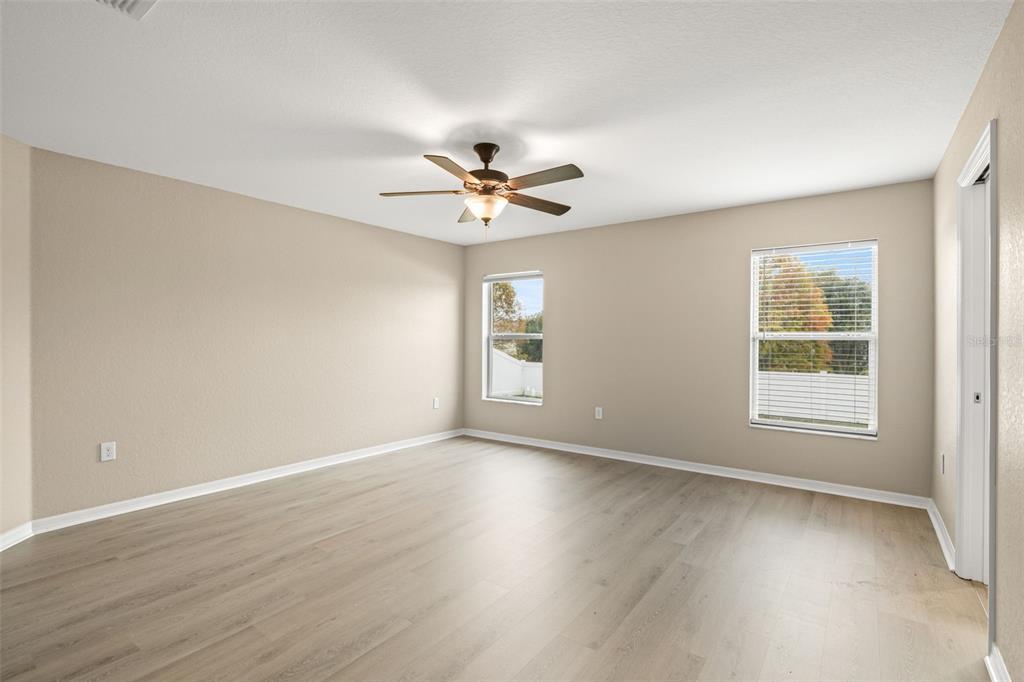 3878 White Ibis Road Lakeland, FL 33811 - Photo 10 of 21 an empty room with wooden floor and windows