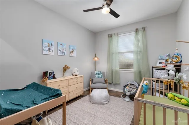 a bedroom with furniture a rug toys and a window